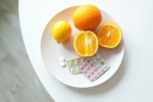 Citrus fruit with supplements on a white plate