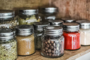 Glass spice jars filled with colorful herbs and spices