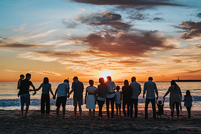 Santa Bárbara arraigada: un grupo muy unido de personas en una playa al atardecer