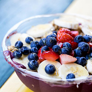 Getting Started - fresh berries and bananas in a breakfast bowl with almond milk