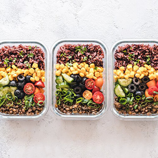 Colorful prepared vegetarian meals in three containers