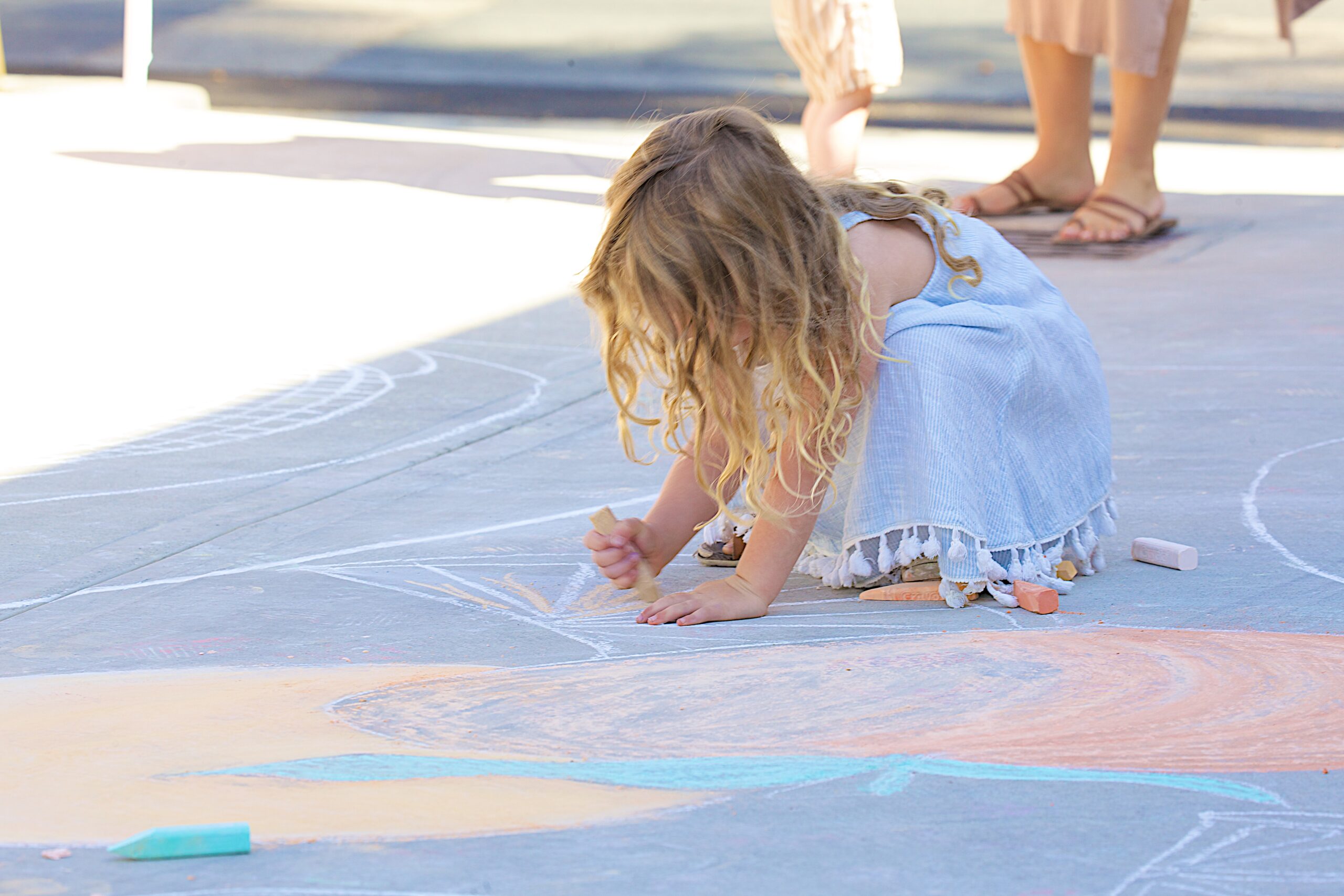 Child coloring chalk mural