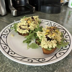 High protein avocado toast with tofu, pistachios and arugala